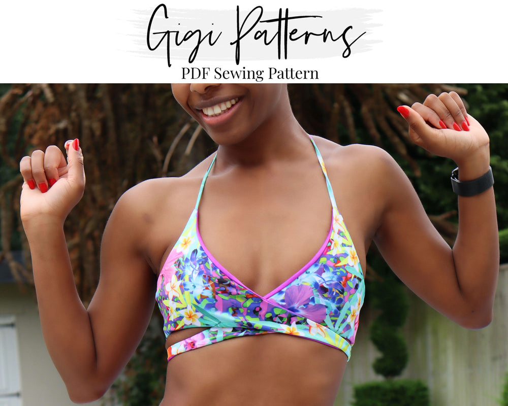 Reversible wrap bikini top sewing pattern with halter neckline and underbust tie. Features a floral print on one side and solid colour on the reverse. Adjustable neck and back ties. Includes sizes XS, S, M, L, XL, 2XL, 3XL, 4XL. Comes as a digital PDF download in A4, US Letter, and A0 formats. Includes sew-along video tutorial for beginners.