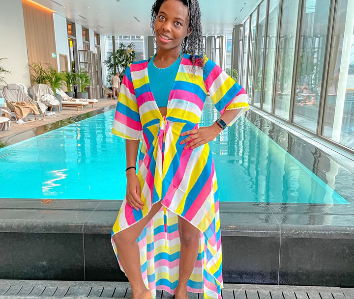 Swimsuit and beach cover-up sewing pattern. Includes a short sleeve cover-up with open front, waist tie, and high-low hem. Swimsuit features a sporty scoop neck top and mid-rise bottom. Digital PDF includes A4, US Letter, and A0 formats. Sizes XS, S, M, L, XL, 2XL, 3XL, 4XL, 5XL. Step-by-step video tutorial included. Beach cover-up pattern, swimwear PDF, fashion designer resortwear.